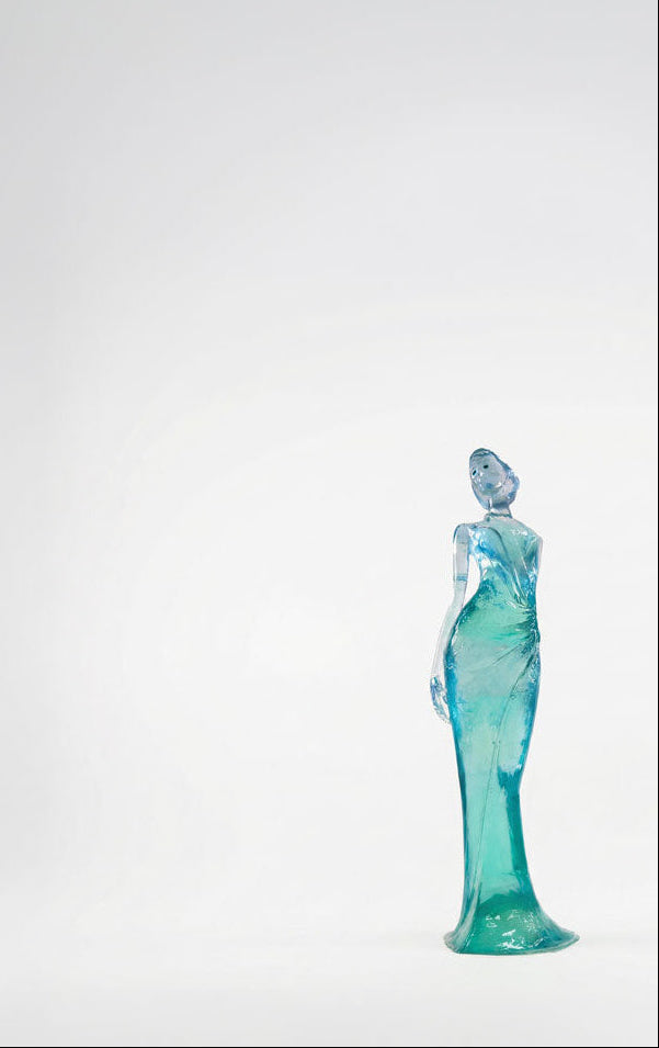 Turquoise glass sculpture on a white background